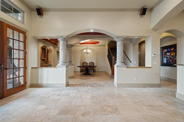 11913 Preserve Vista Ter, Austin, TX 78738 - foyer entrance with ornate columns, a towering ceiling, stone tile flooring, baseboards, and ornamental molding