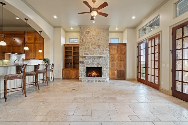 11913 Preserve Vista Ter, Austin, TX 78738 - living area with plenty of natural light, crown molding, ceiling fan, stone tile floors, and recessed lighting