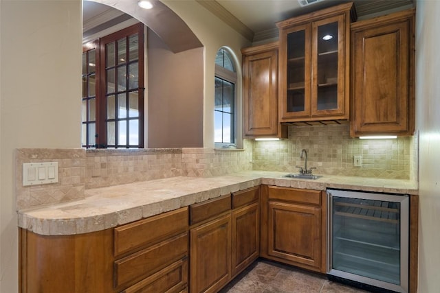11913 Preserve Vista Ter, Austin, TX 78738 - indoor wet bar with wine cooler, crown molding, tasteful backsplash, and arched walkways