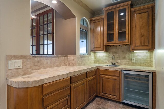 11913 Preserve Vista Ter, Austin, TX 78738 - bar with wine cooler, ornamental molding, a sink, decorative backsplash, and arched walkways
