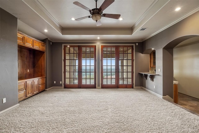 11913 Preserve Vista Ter, Austin, TX 78738 - unfurnished living room featuring french doors, crown molding, light carpet, arched walkways, and a ceiling fan