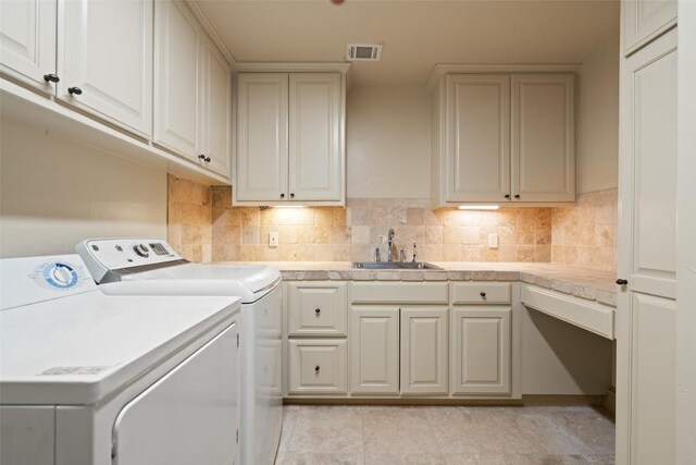 11913 Preserve Vista Ter, Austin, TX 78738 - laundry room with washing machine and clothes dryer, cabinet space, and light tile patterned flooring