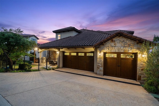 11913 Preserve Vista Ter, Austin, TX 78738 - mediterranean / spanish house with stone siding, concrete driveway, an attached garage, and a tiled roof