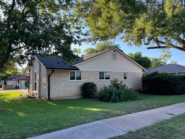 2608 Coatbridge Dr, Austin, TX 78745 - view of property exterior featuring a yard and stone siding