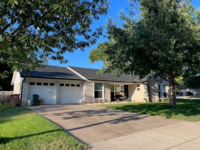 2608 Coatbridge Dr, Austin, TX 78745 - ranch-style house featuring a garage, driveway, and a front yard
