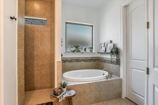 340 Fort Cobb Way, Georgetown, TX 78628 - bathroom featuring a garden tub, tiled shower, and tile patterned floors