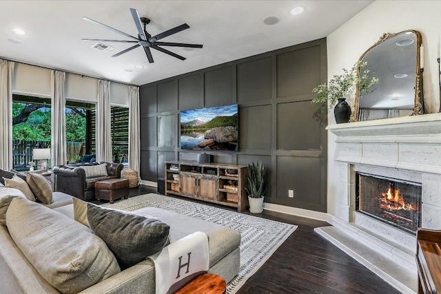 340 Fort Cobb Way, Georgetown, TX 78628 - living area with a decorative wall, ceiling fan, recessed lighting, dark wood finished floors, and a warm lit fireplace