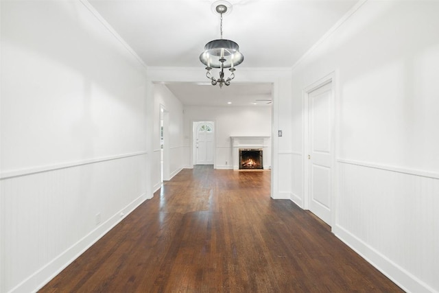 1114 Reagan Ter, Austin, TX 78704 - hall with wood finished floors, a wainscoted wall, ornamental molding, a decorative wall, and a chandelier