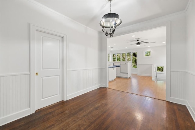 1114 Reagan Ter, Austin, TX 78704 - unfurnished dining area featuring wood-type flooring, a wainscoted wall, ceiling fan, and a chandelier