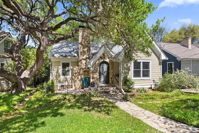 1114 Reagan Ter, Austin, TX 78704 - view of front facade with a front yard, a chimney, and stone siding