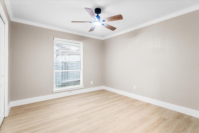 unfurnished room featuring a ceiling fan, light wood-style floors, baseboards, and ornamental molding