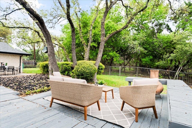 wooden deck with outdoor dining space, outdoor lounge area, and fence