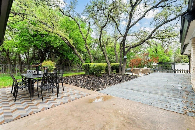 view of patio / terrace with outdoor dining space, a deck, and fence private yard