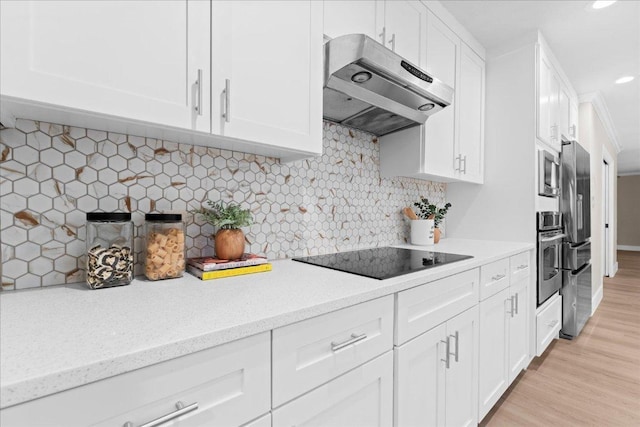 10616 Spicewood Pkwy, Austin, TX 78750 - kitchen with stainless steel appliances, under cabinet range hood, white cabinetry, recessed lighting, and light wood-type flooring