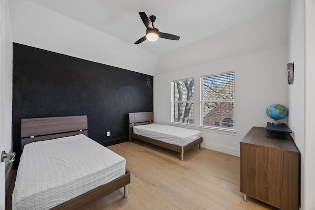 1409 Vibar Cv, Round Rock, TX 78681 - bedroom with light wood-style flooring, vaulted ceiling, and a ceiling fan
