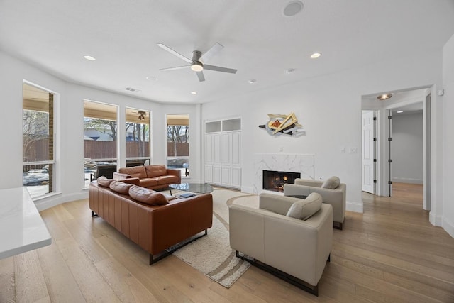 1409 Vibar Cv, Round Rock, TX 78681 - living room featuring a ceiling fan, a fireplace, light wood-type flooring, and recessed lighting
