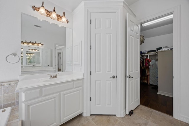 1409 Vibar Cv, Round Rock, TX 78681 - full bath featuring vanity, a walk in closet, a bathtub, and tile patterned flooring