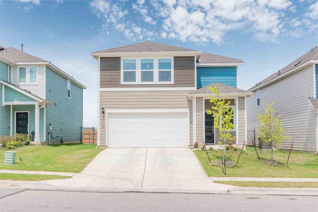 traditional-style home with an attached garage, a front yard, fence, and driveway