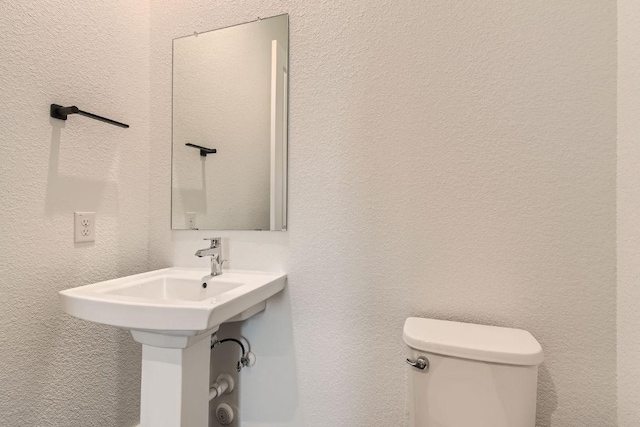 300 Alava Way, Georgetown, TX 78628 - half bath featuring toilet and a textured wall