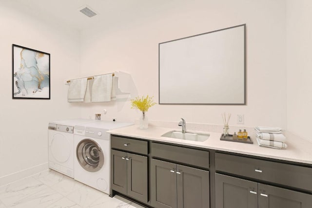 300 Alava Way, Georgetown, TX 78628 - washroom with washer and dryer, cabinet space, light marble finish floors, and baseboards