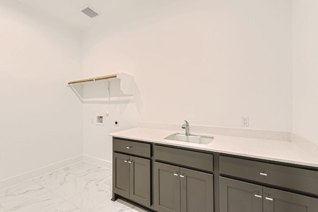 300 Alava Way, Georgetown, TX 78628 - washroom with hookup for a washing machine, electric dryer hookup, baseboards, light marble finish floors, and cabinet space