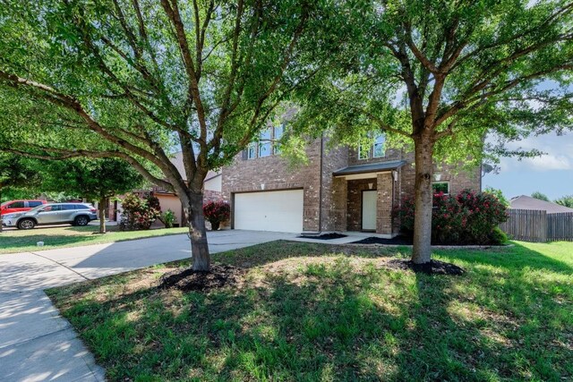 1114 Sussex Pl, Round Rock, TX 78665 - view of front of home featuring driveway, a garage, and brick siding