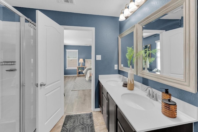 ensuite bathroom featuring ensuite bathroom, a sink, and a stall shower