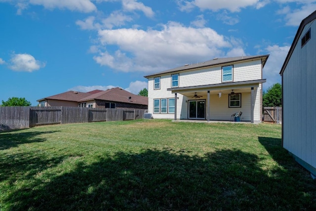 rear view of house featuring central air condition unit, a fenced backyard, a ceiling fan, and a lawn