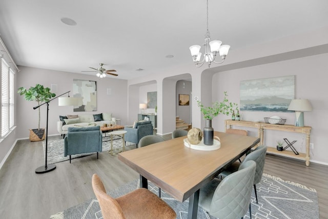 1114 Sussex Pl, Round Rock, TX 78665 - dining room with arched walkways, wood finished floors, ceiling fan, and a chandelier