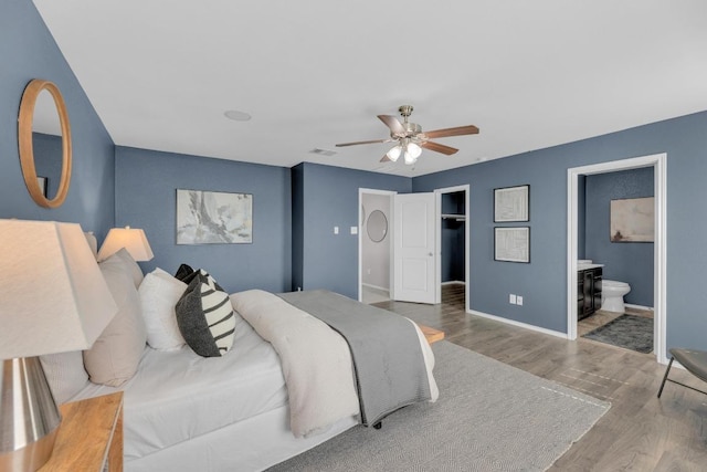1114 Sussex Pl, Round Rock, TX 78665 - bedroom featuring wood finished floors, ensuite bath, ceiling fan, and a closet