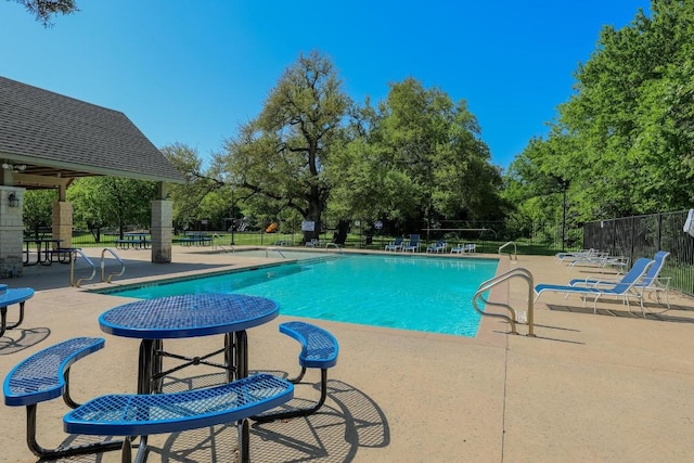 1114 Sussex Pl, Round Rock, TX 78665 - community pool with a patio and view of wooded area