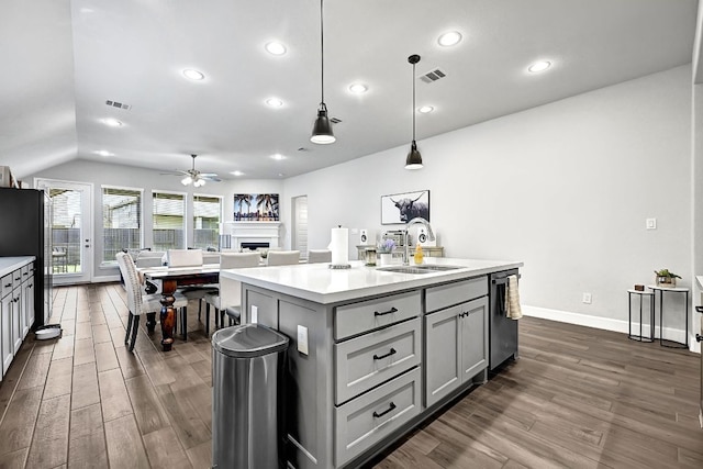 2831 Tanager Trce, Katy, TX 77493 - kitchen featuring gray cabinets, a fireplace, dark wood-style flooring, ceiling fan, and light countertops