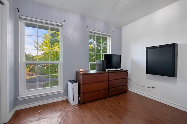 bedroom featuring baseboards and wood finished floors