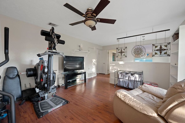 living area featuring ceiling fan, visible vents, and wood finished floors