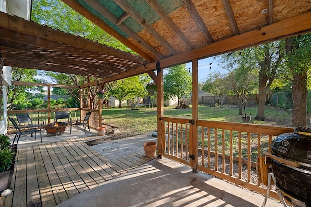 deck with a yard, a fire pit, and a fenced backyard