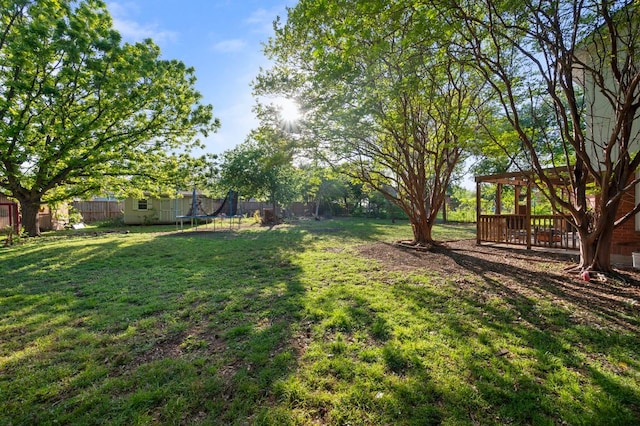 view of yard with a fenced backyard and a trampoline