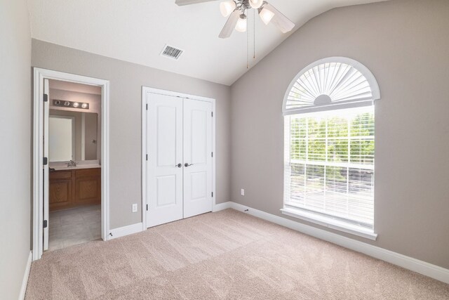 103 Aria Rdg Unit 902, Austin, TX 78738 - unfurnished bedroom with light colored carpet, vaulted ceiling, a closet, ensuite bath, and a ceiling fan