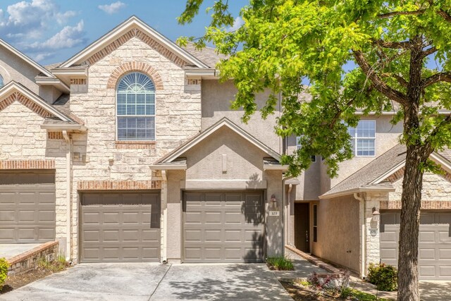 103 Aria Rdg Unit 902, Austin, TX 78738 - view of front of house with stone siding, stucco siding, driveway, and a garage