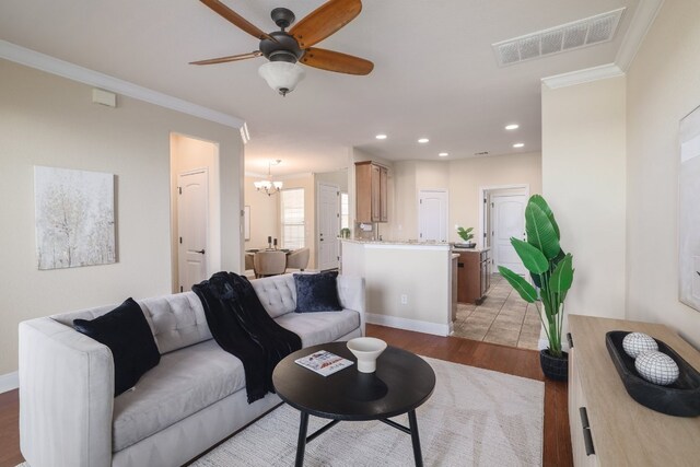 103 Aria Rdg Unit 902, Austin, TX 78738 - living room with light wood finished floors, crown molding, recessed lighting, ceiling fan, and a chandelier