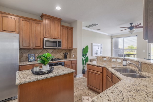 103 Aria Rdg Unit 902, Austin, TX 78738 - kitchen with stainless steel appliances, backsplash, light stone countertops, crown molding, and ceiling fan