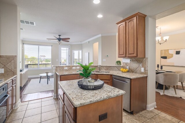 103 Aria Rdg Unit 902, Austin, TX 78738 - kitchen featuring appliances with stainless steel finishes, crown molding, ceiling fan, a peninsula, and a center island