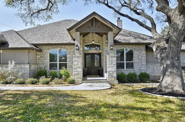 1609 Havenwood Blvd, New Braunfels, TX 78132 - entrance to property featuring stone siding, a chimney, a yard, and a shingled roof