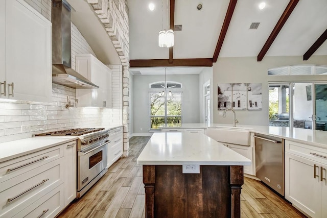 1609 Havenwood Blvd, New Braunfels, TX 78132 - kitchen featuring appliances with stainless steel finishes, wall chimney range hood, light wood-style floors, a sink, and light countertops