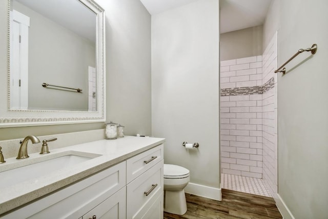1609 Havenwood Blvd, New Braunfels, TX 78132 - full bath featuring toilet, a tile shower, vanity, wood finished floors, and baseboards