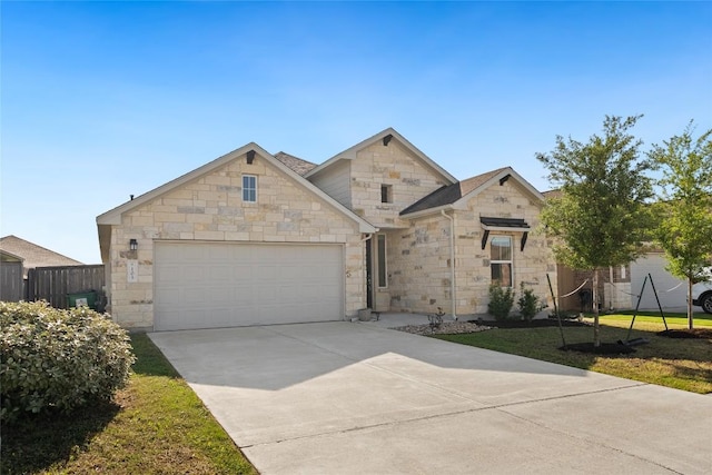 105 Lemuel Crawford Trl, Bastrop, TX 78602 - view of front of property featuring a front yard, fence, stone siding, an attached garage, and concrete driveway