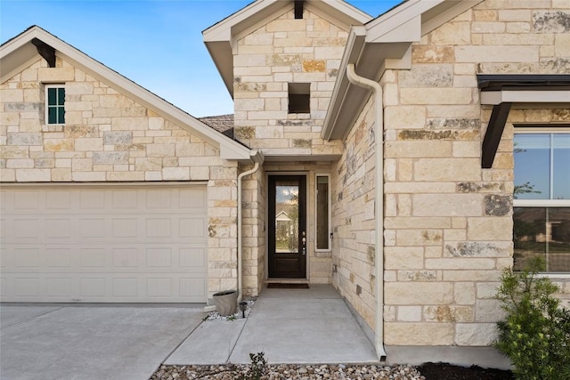 105 Lemuel Crawford Trl, Bastrop, TX 78602 - doorway to property featuring concrete driveway, stone siding, and an attached garage