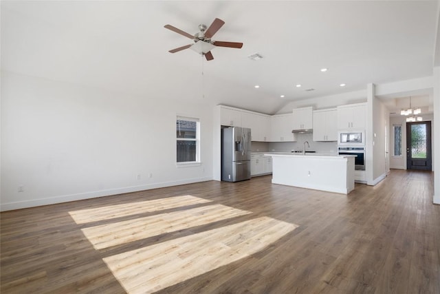 105 Lemuel Crawford Trl, Bastrop, TX 78602 - unfurnished living room featuring ceiling fan with notable chandelier, a sink, baseboards, and recessed lighting