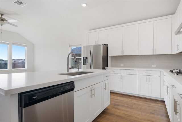 105 Lemuel Crawford Trl, Bastrop, TX 78602 - kitchen with visible vents, light countertops, ceiling fan, stainless steel appliances, and decorative backsplash