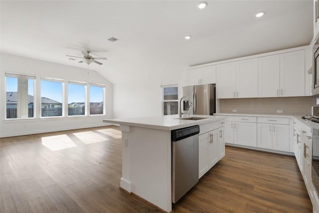 105 Lemuel Crawford Trl, Bastrop, TX 78602 - kitchen with tasteful backsplash, an island with sink, a ceiling fan, appliances with stainless steel finishes, and a sink