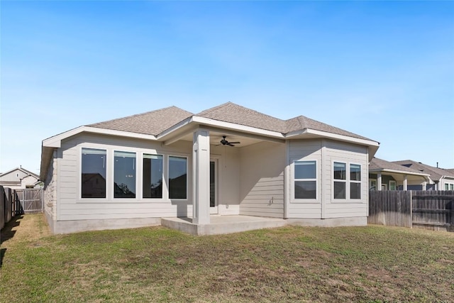 105 Lemuel Crawford Trl, Bastrop, TX 78602 - rear view of house with roof with shingles, a ceiling fan, a patio area, a fenced backyard, and a lawn